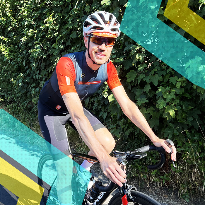 A man cycling with Surrey Cycling Club on a road in Surrey.