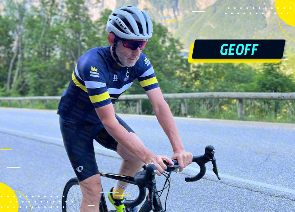 A cyclist from Surrey Cycling Club rides through a scenic mountainous road.