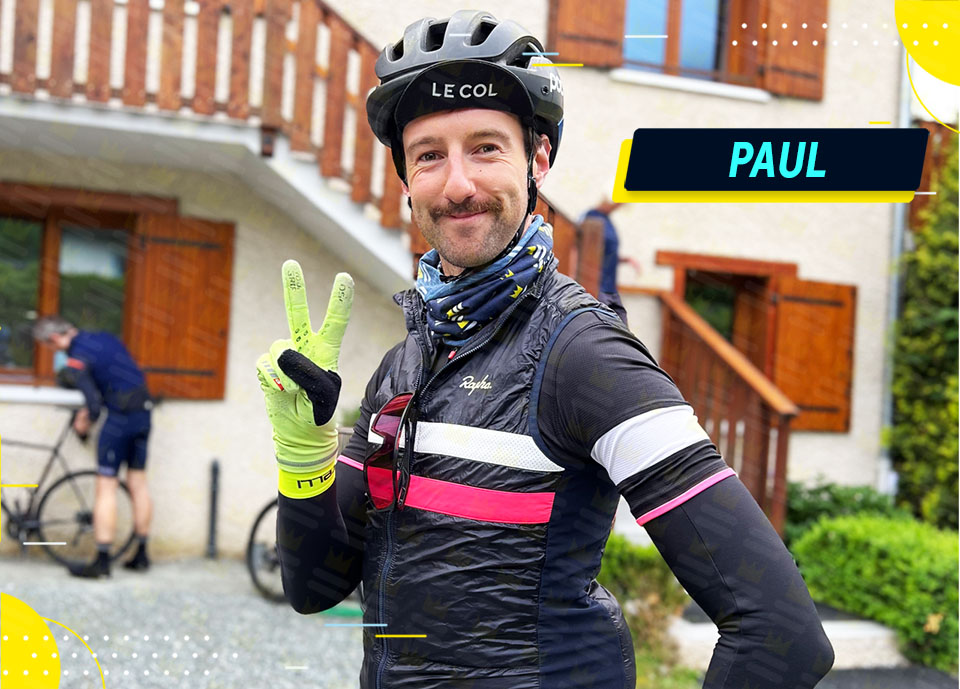 A man in a bike helmet is posing for a photo.