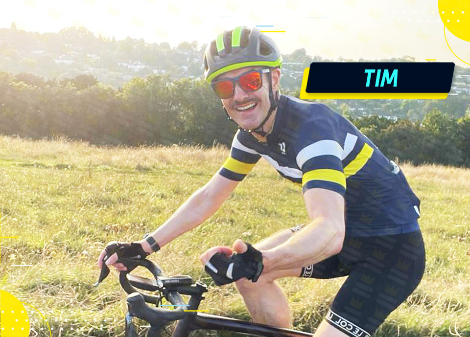 A man riding a bike in a field.