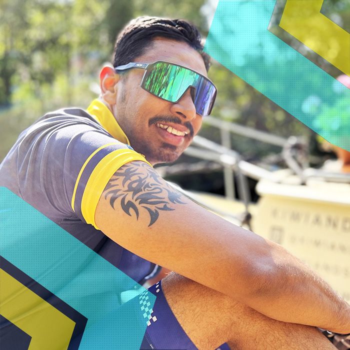 A man sitting on a boat in Surrey Cycling Club with sunglasses on.